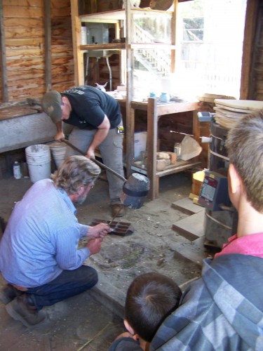 Eric  pouring aluminum in the foundry.