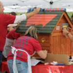 Levi Strauss employees painting doghouse