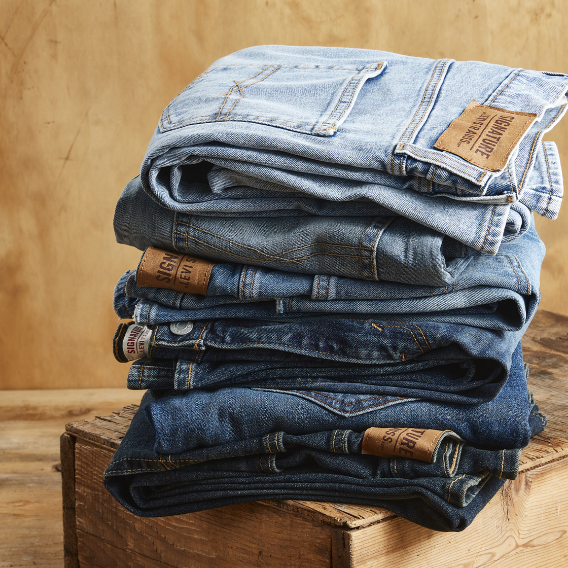 a pile of folded Signature by Levi Strauss jeans.