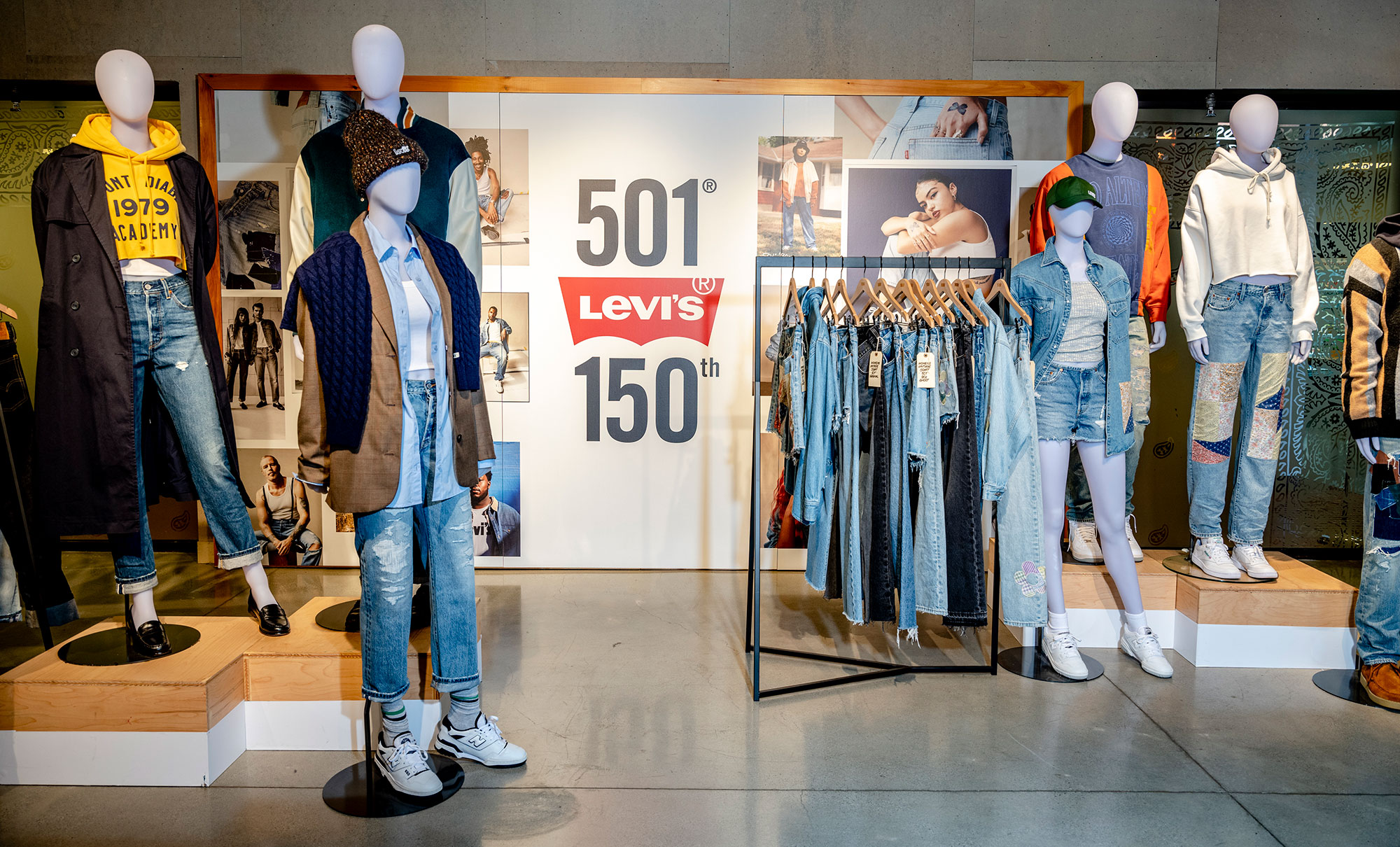 The interior of a Levi's® store showcasing mannequins and hanging displays of Levi's® 501® products. A sign reads 501® Levi's® 150th.