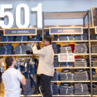 2 retail employees stocking 501® jeans in a Levi's® store