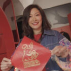 Greater China managing director Amy Yang holds up a Year of the Rabbit red envelope.