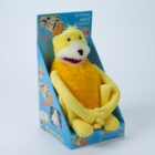 "Flat Eric," a yellow plush puppet, sits packaged in a box.