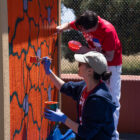 Two LS&Co. employees paint a mural.