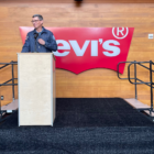 CEO Chip Bergh standing at a podium in front of the Levi's batwing logo