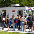 A group of community college students line up by a white truck with the Levi's® logo reading "It's your voice. it's your vote."