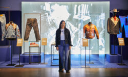 LS&Co. Historian Tracey Panek stands in front of the new Levi's® exhibition, Icons, Innovations & Firsts — Stories of Heritage and Progress From the Levi’s® Archives.