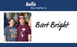 A name badge design. A blue header reads "hello my name is." Below, an image of Bart Bright at a Disney park next to "Bart Bright" in black script.