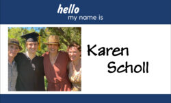 A name badge design. A blue header reads "hello my name is." Below, an image of Karen Scholl and family at a graduation next to "Karen Scholl" in black script.