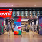 The entrance to the Levi's® store in Pacific Mall in Tagore Garden, New Dehli, featuring a large Levi's® logo above an entrance opening into an LED animation screen and assorted products.