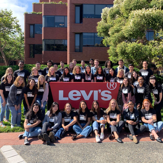 group of LS&Co. interns in front of Levi's sign at the San Francisco headquarters