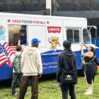 Community college students stand in line to receive free pizza at a "Pizza to the Polls" food truck