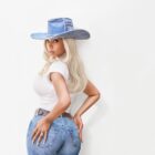 Beyonce wearing a Levi's denim cowboy hat, white T-shirt and 90s 501s looking over her shoulder at the camera