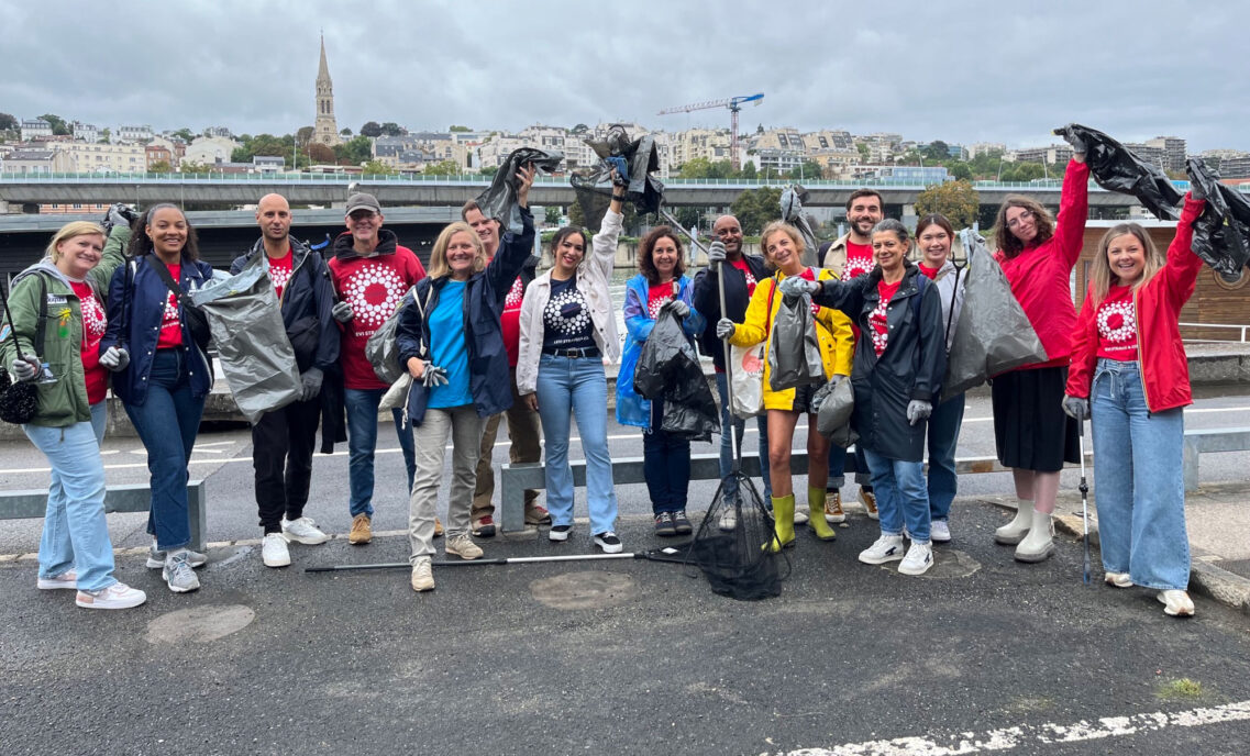 A group of LS&Co. employees pose with clean up supplies as they volunteer on LS&Co.'s annual Community Day 2024