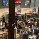 A photo taken from an upper perspective looking down into a Levi's® store, featuring shelves of jeans and product displays