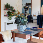 Interior of Levi's® Haus of Strauss Paris featuring plants, racks of Levi's® products, a glass table, organ plus chair and floral centerpiece.