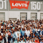 A large group shot of LS&Co. employees in South Africa in front of a sign reading 501 Levi's 150th