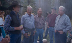 Former President Jimmy Carter, former LS&Co. Chairman Walter Haas, and three guests stand in conversation wearing Levi's® blue jeans at Walter's ranch in Montana.