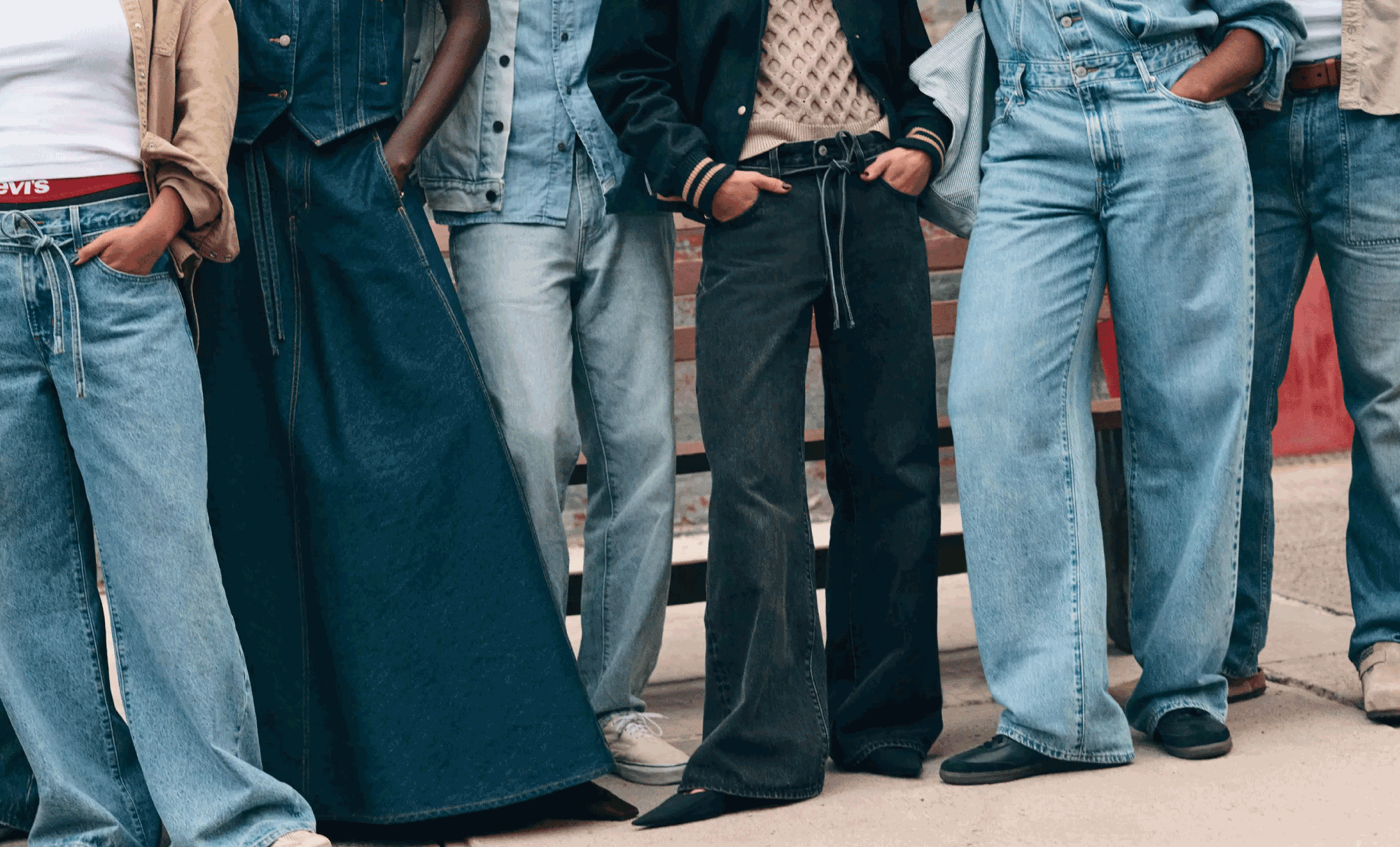 A photo of six people wearing various styles of Levi's® baggy and loose jeans, cropped from the waist down.