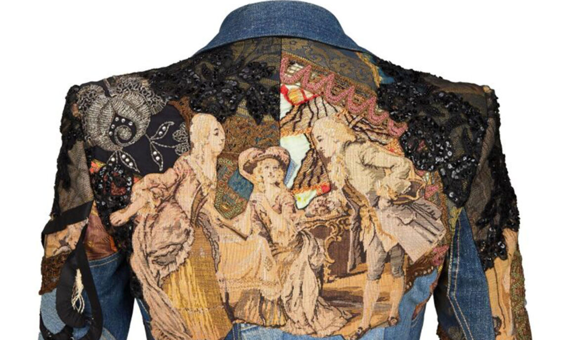 Back of Bill Whitten's denim suit designed for Elton John, featuring intricate tapestry and sequined flowers