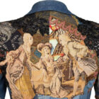 Back of Bill Whitten's denim suit designed for Elton John, featuring intricate tapestry and sequined flowers