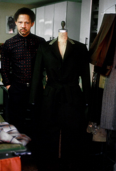 Designer Bill Whitten poses next to one of his designs on a mannequin