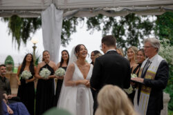 Deb Ambar and her husband smile at the altar on their wedding day