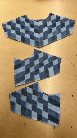 three panels of denim patchwork panels sit on a work surface