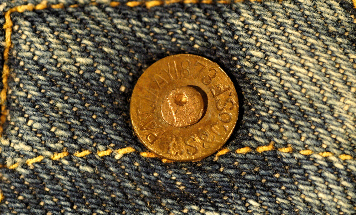 a close up photo of a Levi's metal rivet on denim