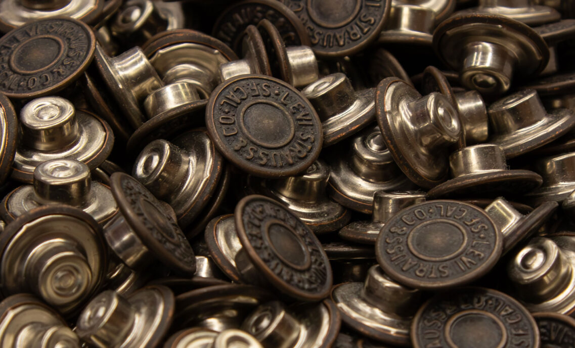 A pile of LS&Co. branded metal rivets